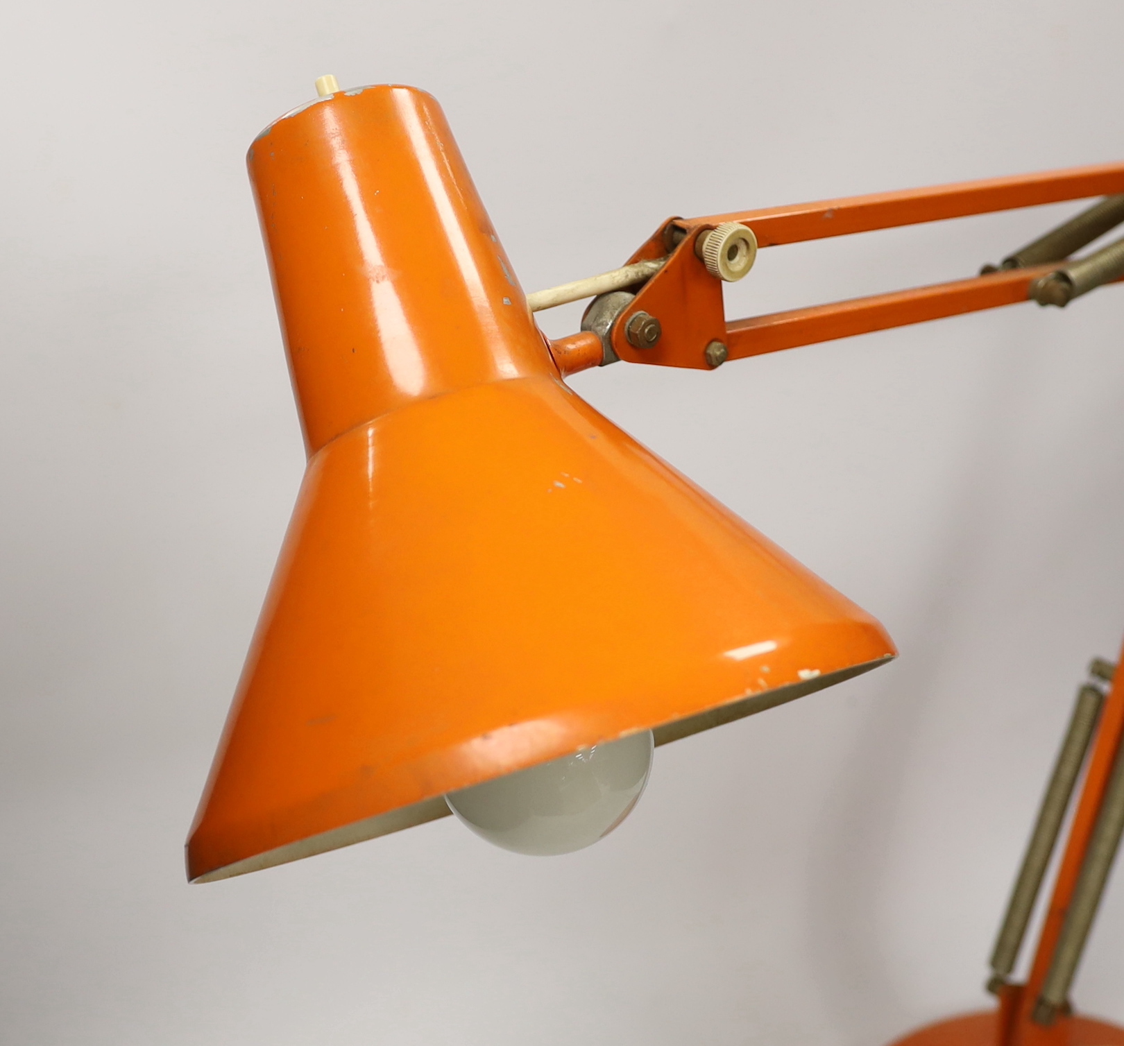 An orange Thousand and One Lamps Ltd angle poise lamp, approximately 76cm high